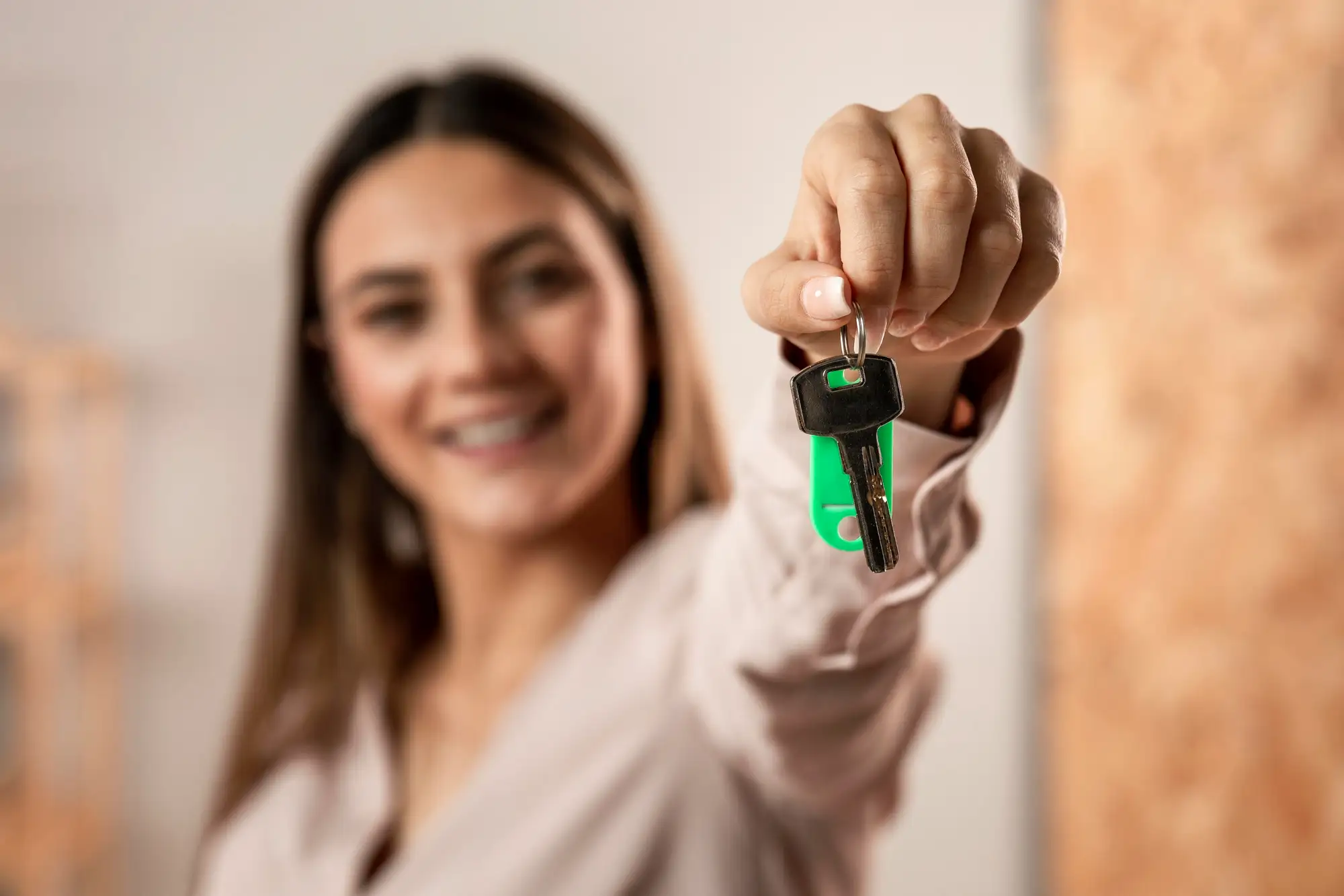 Franquia imobiliária: mulher segurando chaves e chaveiro